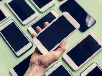 Hand holding smartphone with smartphone on background nidnoiit, nidnoiit.com, นิดหน่อยไอที, นิดหน่อย ไอที, ร้านนิดหน่อย, ขาย, จำนำ, ขายฝาก, มือสอง, สินค้ามือสอง, สินค้าไอที, โทรศัพท์มือถือ, Smartphone, iPhone, iPad, Tablet, Samsung, กล้องDSLR, กล้องmirrorless, โน๊ตบุ๊ค, Notebook, คอมพิวเตอร์, PC, ทีวี, TV, เครื่องเสียง, เกมPSP4, Nintendo, Gopro, iPadPro, IPhone4, IPhone5, IPhone5s, IPhone6, IPhone6s, IPhone7, IPhone8, IPhonex, IPhonexs, IPhonexsmax, IPhonexr, IPhone6plus, IPhone7plus, IPhone8plus, CANON, NIKON, LEICA, Fuji, SONY, OLYMPUS, PANASONIC, CASIO, Apple, Samsung, OPPO, Vivo, Huawei, Xiaomi Mi, Nokia, ASUS, LG, Wiko